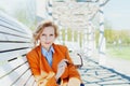 Portrait of happy smiling business woman or fashion girl student with sunglasses sitting on the bench in park outdoor Royalty Free Stock Photo