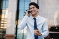 Portrait of a Happy Smiling Businessman Talking on Mobile Phone in the Urban City. Lifestyle of Modern People