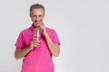 Portrait of Happy Smiling Caucasan Blond Man Holding Cup With Smoothie. Drinking Through Straw Royalty Free Stock Photo