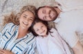 Portrait of happy smiling caucasian family from above relaxing on a carpet floor at home. Carefree loving parents Royalty Free Stock Photo