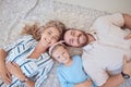 Portrait of happy smiling caucasian family from above relaxing on a carpet floor at home. Carefree loving parents Royalty Free Stock Photo