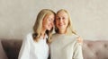 Portrait of happy smiling caucasian middle aged mother hugging her adult daughter together at home Royalty Free Stock Photo