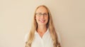 Portrait of happy smiling caucasian middle aged woman employee manager in eyeglasses and looking at camera in office at work or Royalty Free Stock Photo