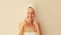 Portrait of happy smiling caucasian middle-aged woman points to her white clean teeth while drying her wet hair with wrapped towel Royalty Free Stock Photo