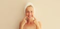 Portrait of happy smiling caucasian middle-aged woman points to her white clean teeth while drying her wet hair with wrapped towel Royalty Free Stock Photo