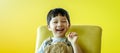 Portrait of happy smiling child boy isolated on yellow background. Portrait of happy joyful laughing beautiful little boy on