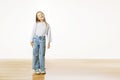 Portrait of a happy smiling child girl standing against white background Royalty Free Stock Photo