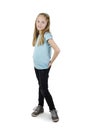 Portrait of happy smiling child girl standing with hands in pocket, full length. Adorable beautiful pretty teenage girl standing.