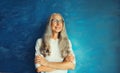 Portrait of happy smiling confident middle-aged woman with crossed arms in eyeglasses looks away. Gray-haired female in casual on Royalty Free Stock Photo