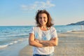 Portrait of happy smiling confident middle aged woman on beach Royalty Free Stock Photo