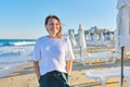 Portrait of happy smiling confident middle aged woman on beach Royalty Free Stock Photo