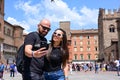 Portrait of happy smiling Couple at Bologna . tourist in Italy Happy Bearded man kissing and hugging on the streets of Italy Royalty Free Stock Photo