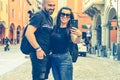 Portrait of happy smiling Couple at Bologna . tourist in Italy Happy Bearded man kissing and hugging on the streets of Italy Royalty Free Stock Photo