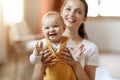 Portrait of happy smiling cute baby and mother at home Royalty Free Stock Photo