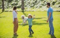 Portrait of a happy smiling family with dog relaxing in park. Royalty Free Stock Photo