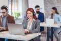 Portrait of happy smiling female customer support phone operator Royalty Free Stock Photo