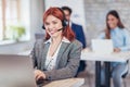 Portrait of happy smiling female customer support phone operator Royalty Free Stock Photo