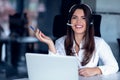 Portrait of happy smiling female customer support phone operator at workplace. Royalty Free Stock Photo