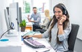 Portrait of happy smiling female customer support phone operator at workplace. Royalty Free Stock Photo