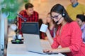 Portrait of happy smiling female customer support phone operator at workplace. Royalty Free Stock Photo