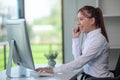 Portrait of happy smiling female customer support phone operator at workplace. Asian Royalty Free Stock Photo