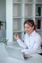 Portrait of happy smiling female customer support phone operator at workplace. Asian Royalty Free Stock Photo