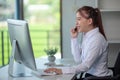 Portrait of happy smiling female customer support phone operator at workplace. Asian Royalty Free Stock Photo