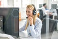 Portrait of happy smiling female customer support phone operator at workplace. Royalty Free Stock Photo