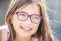 Portrait of happy smiling girl with dental braces and glasses Royalty Free Stock Photo