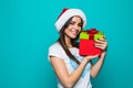 Portrait of a happy smiling girl in dress holding present box over green background Royalty Free Stock Photo