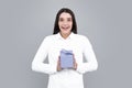 Portrait of a happy smiling girl holding present box and isolated over gray background. Royalty Free Stock Photo