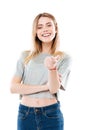 Portrait of a happy smiling girl pointing finger at camera Royalty Free Stock Photo