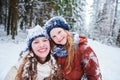 Portrait of happy smiling girls in winter snowy forest