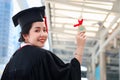 Portrait of happy smiling graduated student showing her gold medal award, Asian woman looking at camera so proud on commencement Royalty Free Stock Photo