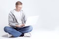 Portrait of Happy Smiling Handsome Caucasian Man Sitting with Laptop on Legs. Royalty Free Stock Photo