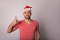 Portrait of a happy smiling handsome man in casual fashionable shirt and red Canta Clause hat Royalty Free Stock Photo