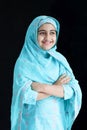 Portrait of happy smiling Indian Muslim girl child in India traditional dress wearing hijab scarf standing with arms crossed on Royalty Free Stock Photo