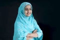 Portrait of happy smiling Indian Muslim girl child in India traditional dress wearing hijab scarf standing with arms crossed on Royalty Free Stock Photo