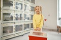 Portrait of happy smiling kid holding plastic cat carrier Royalty Free Stock Photo