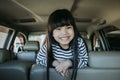 Portrait happy, smiling kid sitting in the car looking out windows, ready for vacation trip Royalty Free Stock Photo