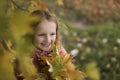 Portrait of a Happy smiling little girl in the autumn park. Cute four years old child enjoying nature outdoors. Royalty Free Stock Photo
