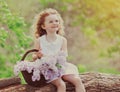 Portrait happy smiling little girl child with bouquet of wildflowers in sunny summer day Royalty Free Stock Photo