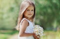 Portrait happy smiling little girl child with bouquet of wildflowers in sunny summer day Royalty Free Stock Photo