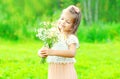 Portrait happy smiling little girl child holding bouquet flowers in her hands in spring Royalty Free Stock Photo