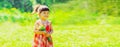 Portrait of happy smiling little girl child outdoors with bouquet of wildflowers walking in sunny summer park Royalty Free Stock Photo