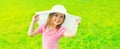 Portrait of happy smiling little girl child wearing summer straw hat in sunny day Royalty Free Stock Photo