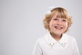 Portrait of a happy smiling little girl school girl on an isolated background. Royalty Free Stock Photo