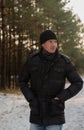 Portrait of happy smiling man in Winter snowy Park