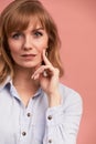 Portrait of a happy smiling mature woman with hand on chin looking at camera. Close up face of beautiful woman with fair Royalty Free Stock Photo