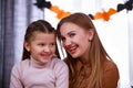 Portrait of a happy smiling mom and daughter. The girl sits in her mother's arms in the room against the background of a Royalty Free Stock Photo